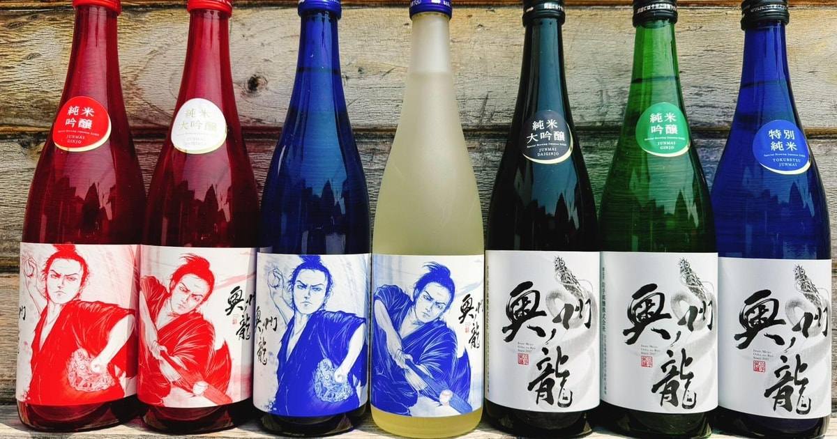 Rows of colorful sake bottles in front of a wooden wall