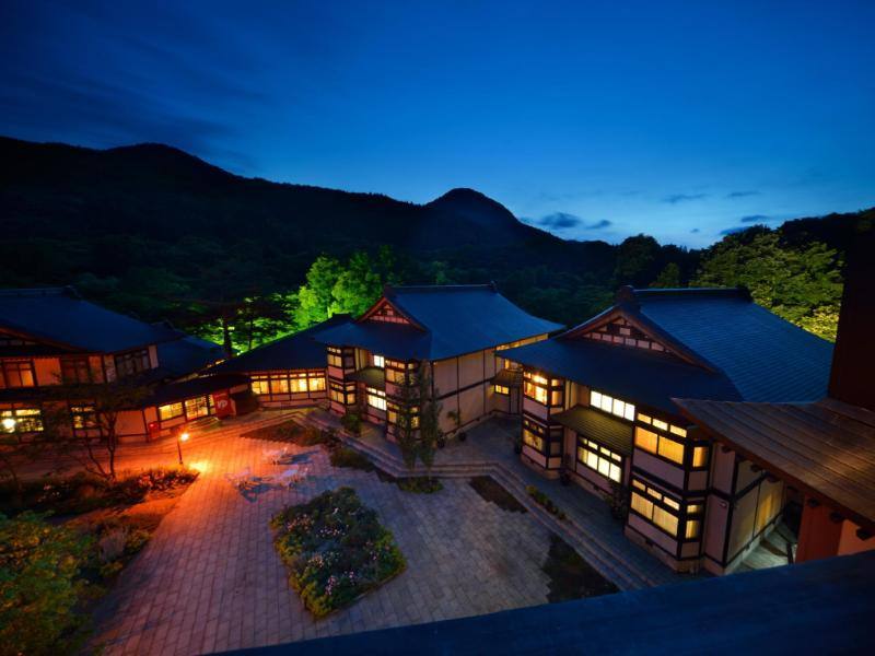 Yukaen Ryokan buildings and illuminated courtyard at dusk